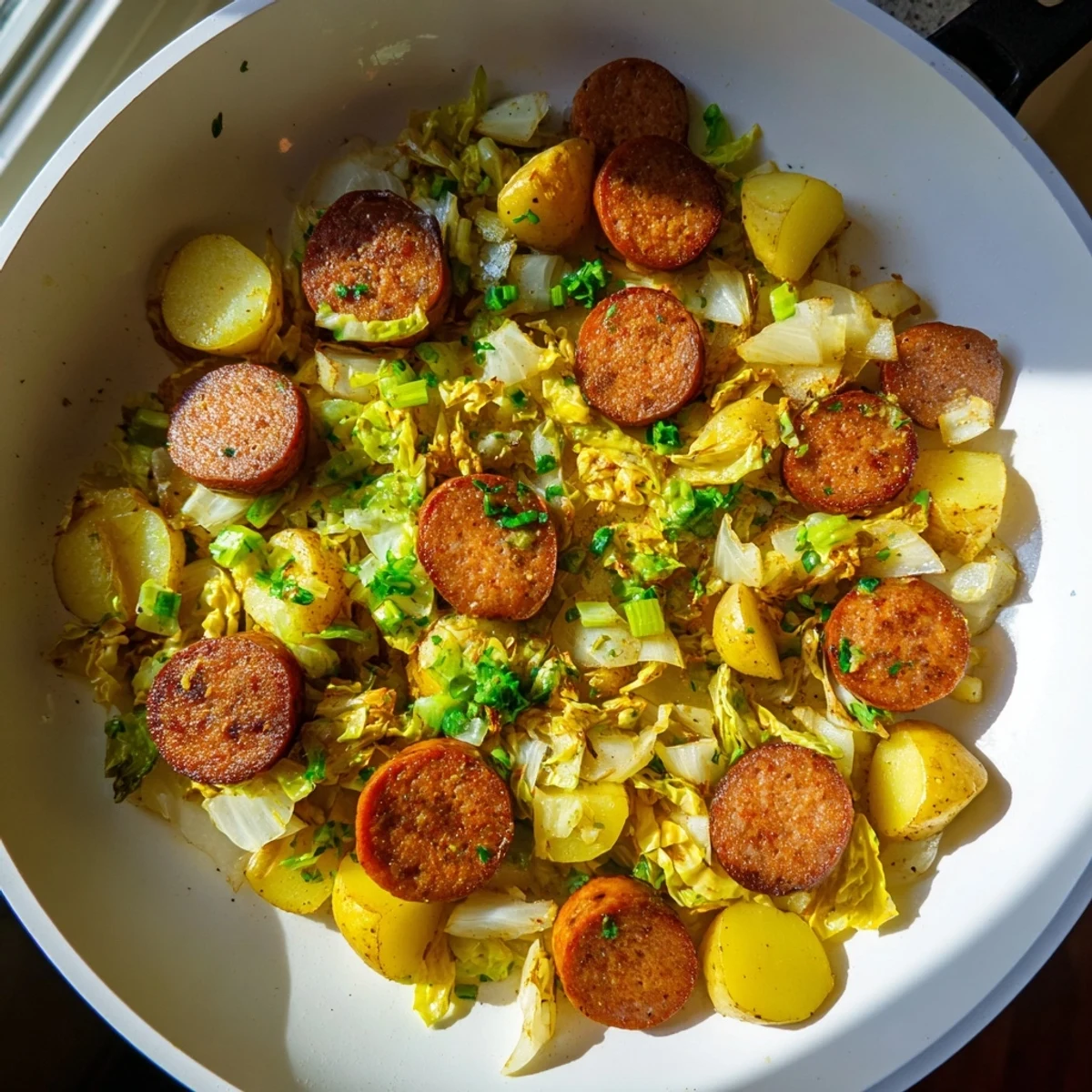 Golden-brown kielbasa and cabbage hash sizzling in a cast-iron skillet, a hearty, rustic treat.
