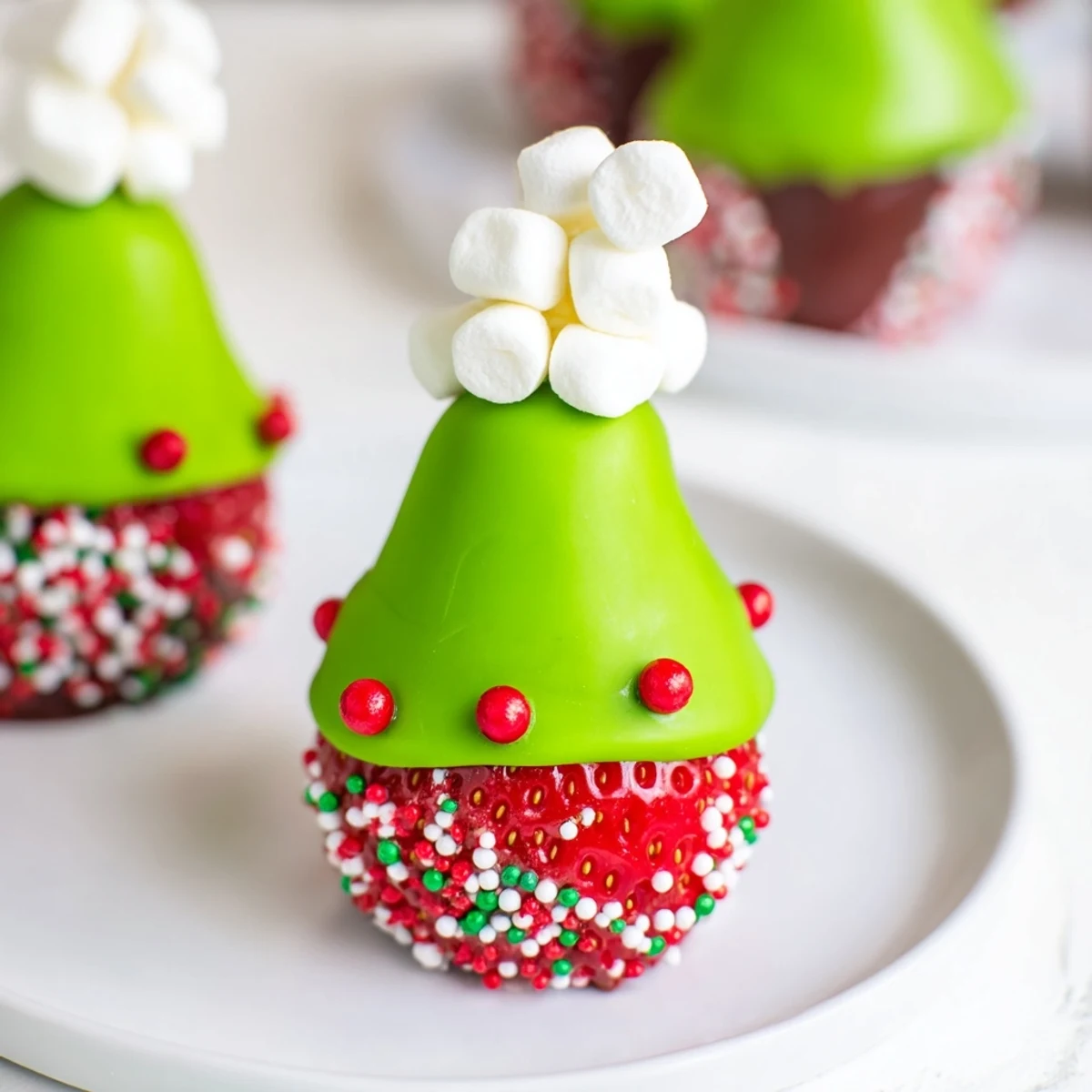 These delightful Elf Hat Chocolate Dipped Strawberries, a fun treat with white chocolate "pom-poms" and candy pearls.