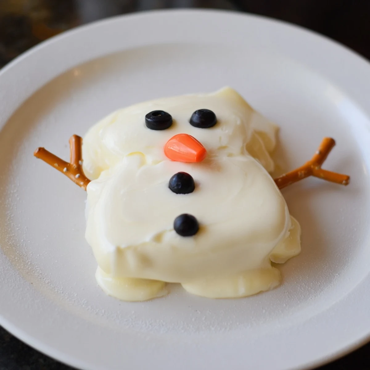 Festive Melted Snowman Cheese Bites are creamy, fun, and served with crackers – a perfect party appetizer.