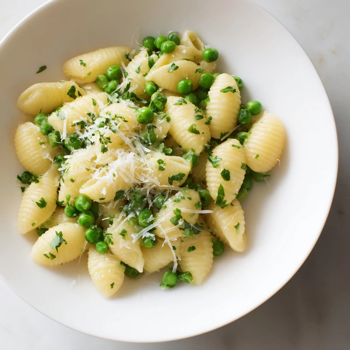 Steaming bowl of Garlic Butter Ditalini with peas, Parmesan, and fresh parsley, ready to eat.