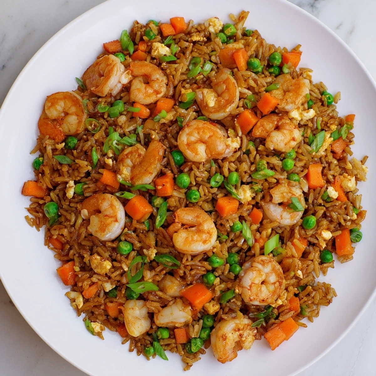 Savory Shrimp Garlic Fried Rice features plump shrimp, fluffy grains, and colorful veggies tossed in a hot wok.  