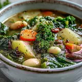 A hearty bowl of Kale Soup featuring kale, cannellini beans, and root vegetables in a savory broth.