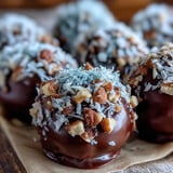 Chocolate Truffles rolled in finely chopped toasted hazelnuts, displayed on a small ceramic dish.