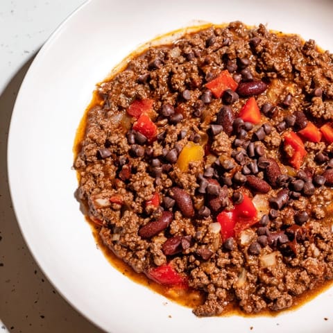 A hearty bowl of this One-Pot Cozy Chocolate Chili, garnished and ready to be enjoyed.