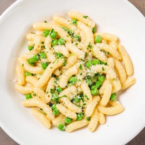 Close-up of golden Garlic Butter Ditalini, showing tender peas and Parmesan, for a quick meal.