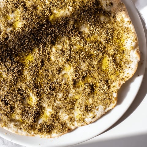 Crispy edges and a flavorful zaatar topping makes this homemade Levantine Zaatar Bread a perfect snack.