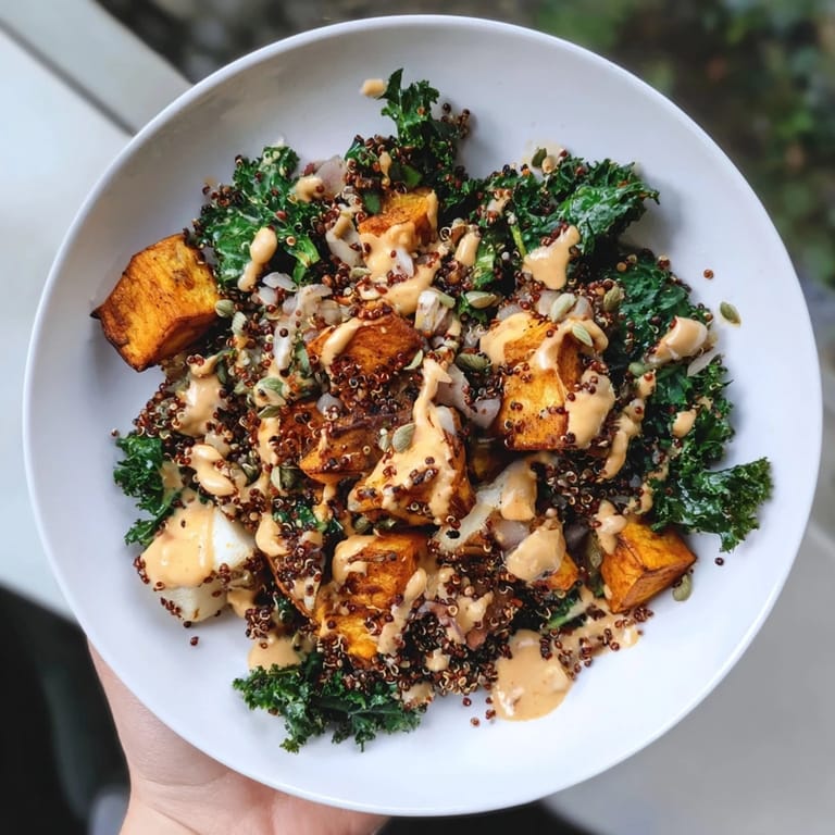 Close-up of a healthy Light Coastal Bowl showcasing roasted sweet potatoes and fresh kale with quinoa.