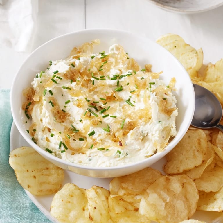 Close-up of crispy potato chips ready to be dipped into the flavorful onion dip.