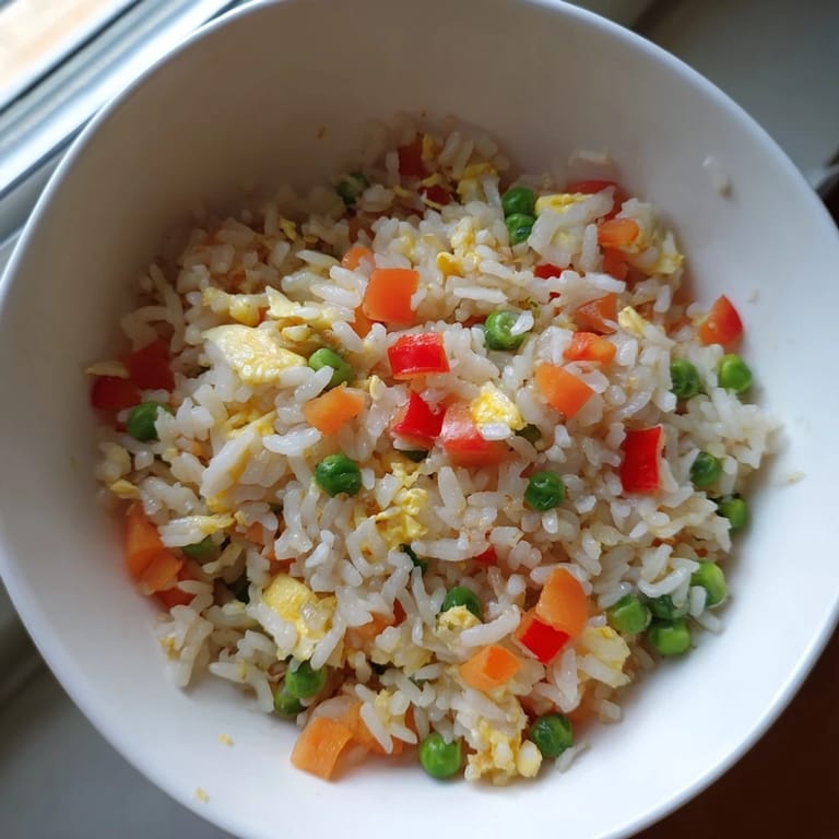 Quick and easy classic Egg Fried Rice served with a side of stir-fried vegetables.