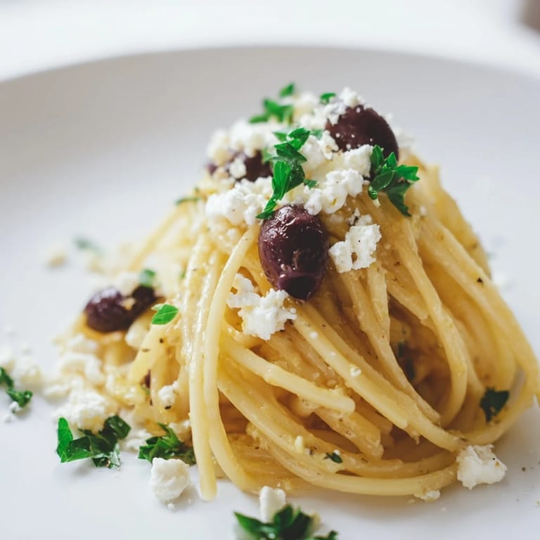 This Greek Chicken Spaghetti recipe features al dente spaghetti tossed with cherry tomatoes, Kalamata olives, and red onion.  