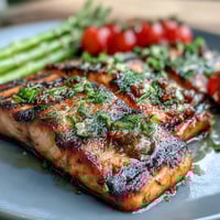 Grilled Lemon Herb Salmon with Asparagus and Cherry Tomatoes, a vibrant, healthy dish featuring juicy salmon fillets marinated in lemon and herbs, grilled to perfection alongside tender asparagus and burst cherry tomatoes. Perfect for a quick, flavorful dinner.