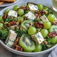 Festive St. Patricks Day green food board with vibrant fruits, veggies, cheeses, and snacks arranged for sharing.  